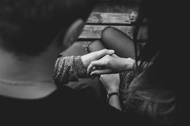 Black and white photo of a couple holding hands at a drug and alcohol rehab centre in Lincolnshire