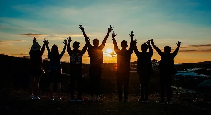 People stood with their arms raised outside of a drug and alcohol rehab Exeter