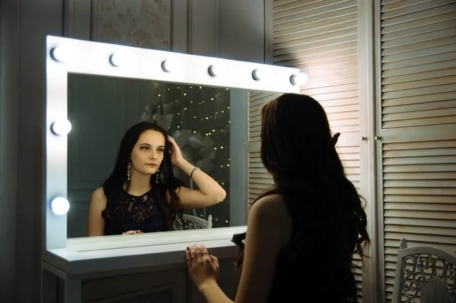 Woman looking in a mirror at a drug and alcohol rehab in Lincolnshire