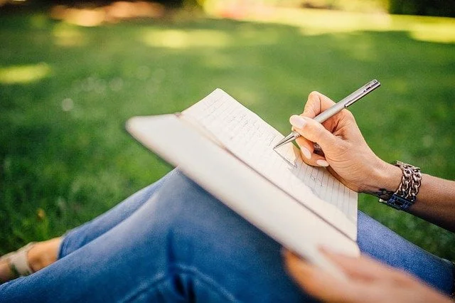 Patient writing in a journal about alcohol addiction at a drug and alcohol rehab in Bolton