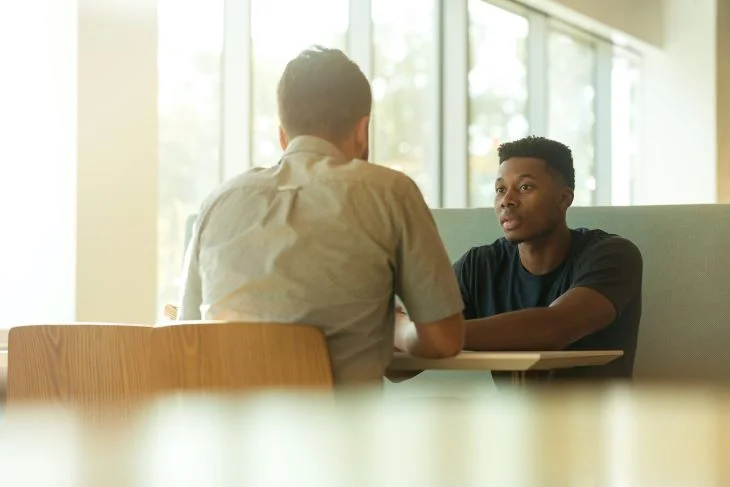 Two men speaking at a drug and alcohol rehab clinic