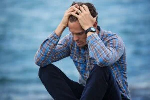 Man in blue shirt looking anxious