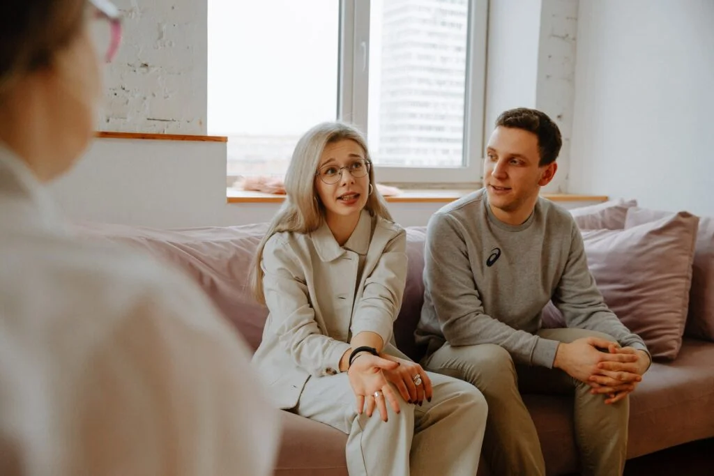 A man and a woman talking with a health professional