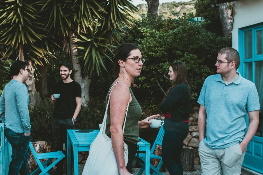 A woman walking through a garden party.