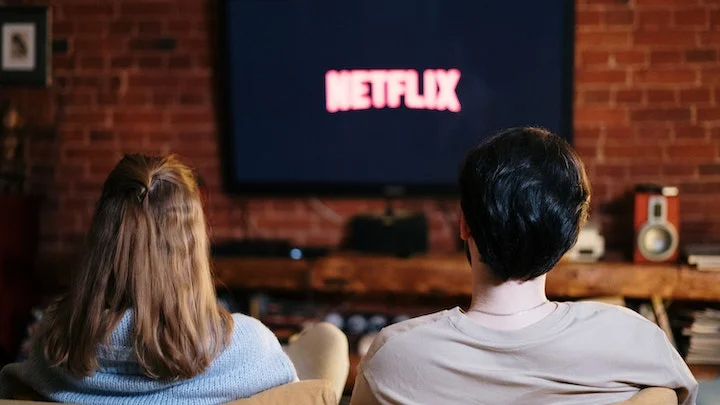 Two young people watching Netflix in Bournemouth