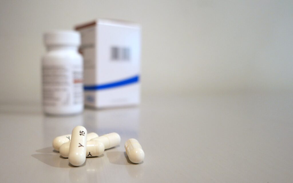 A bottle of medicine with codeine tablets on a counter