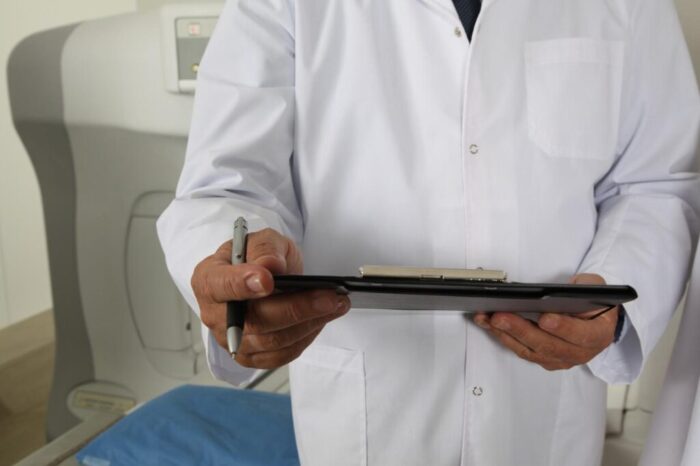 Doctor taking notes at a drug and alcohol rehab in Bedfordshire