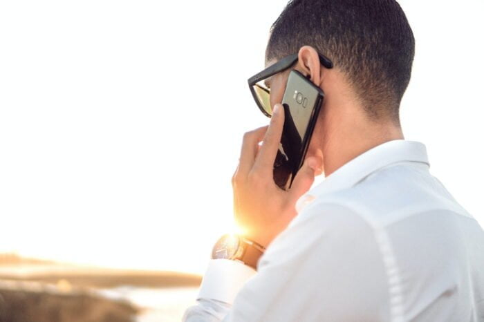 Person talking on a phone for help with UTIs and alcohol abuse