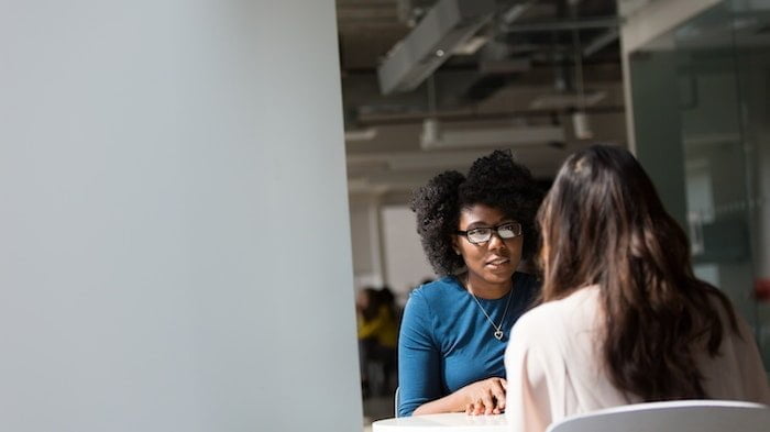 Two women discussing Urinary Tract Infections (UTIs) and alcohol