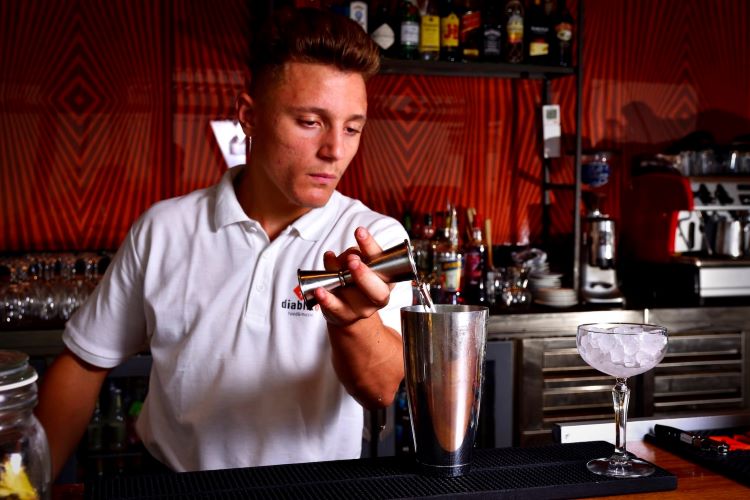 A bartender using a unit measure