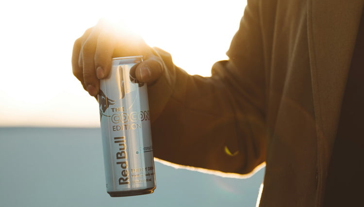 A man holding an energy drink