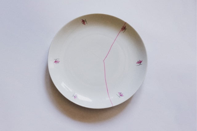 Plate repaired with pink paint in the Kintsugi method